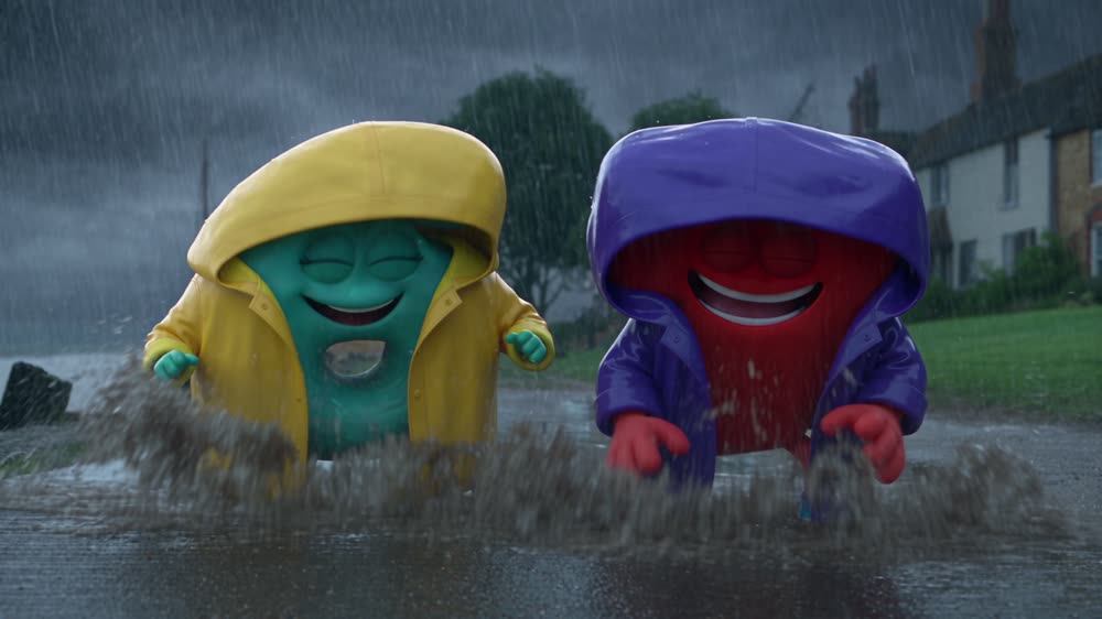 Six and Seven splashing in puddles in raincoats